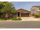 Charming single-story home with a well-maintained lawn, desert landscaping, and a two-car garage in a suburban neighborhood at 20904 E Swan Dr, Queen Creek, AZ 85142