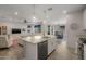 The kitchen features an island with seating and is open to the living room with a ceiling fan at 20904 E Swan Dr, Queen Creek, AZ 85142