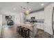 Bright kitchen features white cabinets, granite countertops, and a large island with stool seating at 20904 E Swan Dr, Queen Creek, AZ 85142