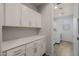 Well-lit laundry room with ample white cabinetry and modern washer/dryer appliances at 20904 E Swan Dr, Queen Creek, AZ 85142