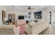 Comfortable living room with a large sectional sofa, vibrant rug, and ceiling fan for a cozy and relaxed atmosphere at 20904 E Swan Dr, Queen Creek, AZ 85142