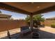 Charming covered patio area with brick pavers, seating and fire pit; perfect for outdoor gatherings at 20904 E Swan Dr, Queen Creek, AZ 85142