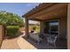 Relaxing covered patio featuring brick pavers, comfortable seating, and views of the backyard at 20904 E Swan Dr, Queen Creek, AZ 85142