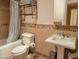 Bathroom showcasing tile backsplash, pedestal sink, and neutral-toned walls at 211 Bahia E Ln, Litchfield Park, AZ 85340