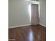 Cozy bedroom with hardwood floors and a curtained window for natural light at 211 Bahia E Ln, Litchfield Park, AZ 85340