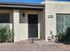 Inviting entrance to home featuring a black security door and manicured landscaping at 211 Bahia E Ln, Litchfield Park, AZ 85340