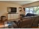 Relaxing living room with large tv and a plush leather reclining sofa at 211 Bahia E Ln, Litchfield Park, AZ 85340