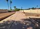 Exterior pathway with Palm Trees along the side of a landscaped community at 211 Bahia E Ln, Litchfield Park, AZ 85340