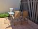 Outdoor patio dining set with table and chairs against a wall and fence at 211 Bahia E Ln, Litchfield Park, AZ 85340