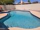 Backyard pool with clear blue water and a surrounding white fence and coping at 211 Bahia E Ln, Litchfield Park, AZ 85340