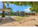 A green backyard with a detached structure and covered patio, perfect for outdoor living at 216 E Harmont Dr, Phoenix, AZ 85020