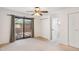 Bedroom with sliding doors leading to a covered patio with brick accents at 216 E Harmont Dr, Phoenix, AZ 85020