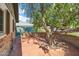 Enclosed courtyard with brick hardscape and shaded by a mature tree at 216 E Harmont Dr, Phoenix, AZ 85020