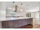 Spacious open-concept kitchen featuring a large island and modern pendant lighting at 216 E Harmont Dr, Phoenix, AZ 85020