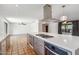 Open-concept kitchen with large island, stainless steel appliances, and view of the living area and backyard at 216 E Harmont Dr, Phoenix, AZ 85020