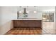 Open-concept kitchen featuring a large island with wood accents and pendant lighting at 216 E Harmont Dr, Phoenix, AZ 85020