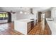 Contemporary kitchen with a central island, gas cooktop, sleek cabinetry, and stainless steel appliances at 216 E Harmont Dr, Phoenix, AZ 85020