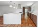 Open-concept kitchen with a large island, stainless steel appliances, and modern lighting fixtures at 216 E Harmont Dr, Phoenix, AZ 85020