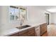 Well-lit kitchen featuring wood cabinets, stainless steel sink, stainless steel appliances, and bright white countertops at 216 E Harmont Dr, Phoenix, AZ 85020