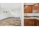Open-concept space with modern wood-look tile, kitchen nook and bright natural light at 216 E Harmont Dr, Phoenix, AZ 85020