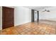 Bright living room featuring tile flooring, a window, and a wooden door at 216 E Harmont Dr, Phoenix, AZ 85020