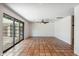 Spacious living room featuring Saltillo tile flooring, ceiling fan, and sliding doors at 216 E Harmont Dr, Phoenix, AZ 85020