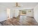 Bright, open living room with wood-look tile flooring and sliding glass doors to the backyard at 216 E Harmont Dr, Phoenix, AZ 85020