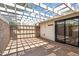 The covered brick patio features a brick accent wall and sliding door to the home at 216 E Harmont Dr, Phoenix, AZ 85020