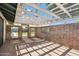 The patio features brick walls with openings and a trellis style overhead covering at 216 E Harmont Dr, Phoenix, AZ 85020