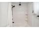Bright shower with a modern shower head and built-in shelving at 216 E Harmont Dr, Phoenix, AZ 85020