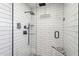 Renovated shower with black fixtures, a rain shower head, and a built-in bench at 216 E Harmont Dr, Phoenix, AZ 85020
