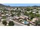 An aerial view of the community featuring neatly landscaped yards, green spaces, neighborhood streets and mountain views at 2210 E Paraiso Dr, Phoenix, AZ 85024