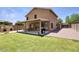 A large green backyard features a BBQ, outdoor kitchen, covered patio, desert landscaping and a pool at 2210 E Paraiso Dr, Phoenix, AZ 85024