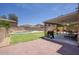 An expansive backyard with a covered patio, outdoor kitchen, BBQ, pool, and desert landscaping at 2210 E Paraiso Dr, Phoenix, AZ 85024