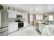 Bright kitchen features white cabinets, stainless appliances, and tile backsplash at 2210 E Paraiso Dr, Phoenix, AZ 85024