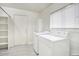 Functional laundry room equipped with washer, dryer, shelving, and a window for natural light at 2210 E Paraiso Dr, Phoenix, AZ 85024