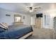 Spacious main bedroom with carpet features a dresser, television, and a doorway to the bathroom at 2210 E Paraiso Dr, Phoenix, AZ 85024
