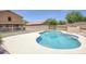 A beautiful backyard pool surrounded by desert landscaping and a white fence for safety at 2210 E Paraiso Dr, Phoenix, AZ 85024