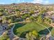 Neighborhood aerial view showcasing a community park with a playground and walking paths surrounded by mature trees at 2432 W Oberlin Way, Phoenix, AZ 85085
