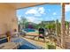 Inviting backyard patio with BBQ, outdoor seating, sparkling pool, and lush desert landscaping for serene relaxation at 2432 W Oberlin Way, Phoenix, AZ 85085