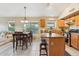 Bright open-plan kitchen featuring stainless steel appliances, center island, and a dining area for Gathering gatherings at 2432 W Oberlin Way, Phoenix, AZ 85085