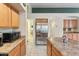 Spacious kitchen featuring stainless steel appliances, a large island and an adjoining pantry for modern convenience at 2432 W Oberlin Way, Phoenix, AZ 85085