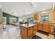 Open kitchen features stainless steel appliances, center island, and tile floors seamlessly blending with the living area at 2432 W Oberlin Way, Phoenix, AZ 85085