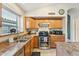 Functional kitchen featuring stainless steel appliances, ample cabinet space, and a center island for culinary adventures at 2432 W Oberlin Way, Phoenix, AZ 85085