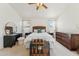 Spacious main bedroom with a ceiling fan, and a rattan chest at the foot of the bed at 2432 W Oberlin Way, Phoenix, AZ 85085