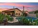 Backyard boasts a beautiful pool and desert landscaping, perfect for relaxation at 2432 W Oberlin Way, Phoenix, AZ 85085