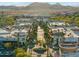 Aerial view of shopping center with palm trees, fountain, street parking, and the mountains in the background at 2432 W Oberlin Way, Phoenix, AZ 85085