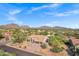 Beautiful aerial shot of a southwestern home with desert landscaping and stunning mountain views at 26475 N Wrangler Rd, Scottsdale, AZ 85255
