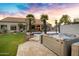 Serene backyard with a sparkling pool, spa, lush landscaping, and inviting seating, creating a private oasis for relaxation at 26475 N Wrangler Rd, Scottsdale, AZ 85255