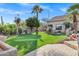 Expansive backyard featuring lush lawn, mature trees, and desert landscaping at 26475 N Wrangler Rd, Scottsdale, AZ 85255